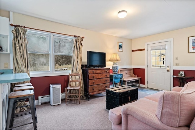 carpeted living area with baseboard heating