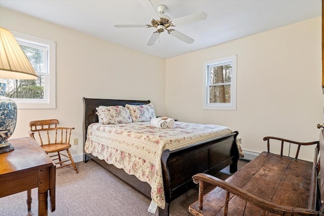 carpeted bedroom featuring a ceiling fan and a baseboard heating unit