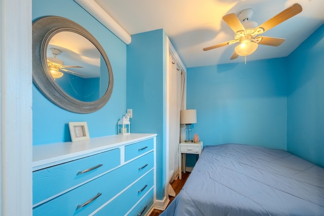 bedroom with ceiling fan and dark wood finished floors