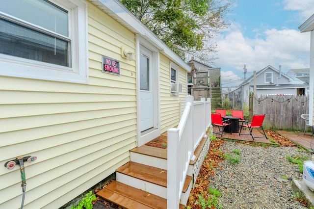 view of side of property with fence, a patio area, and cooling unit