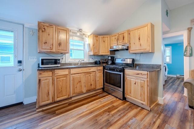 kitchen featuring light brown cabinetry, a sink, light wood finished floors, stainless steel range with gas stovetop, and under cabinet range hood