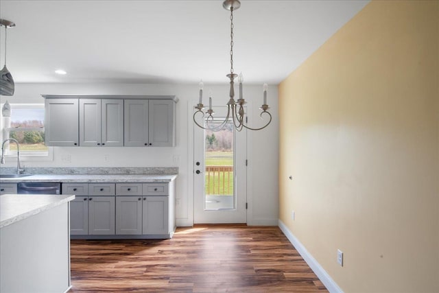kitchen featuring a sink, dishwasher, a chandelier, and gray cabinetry