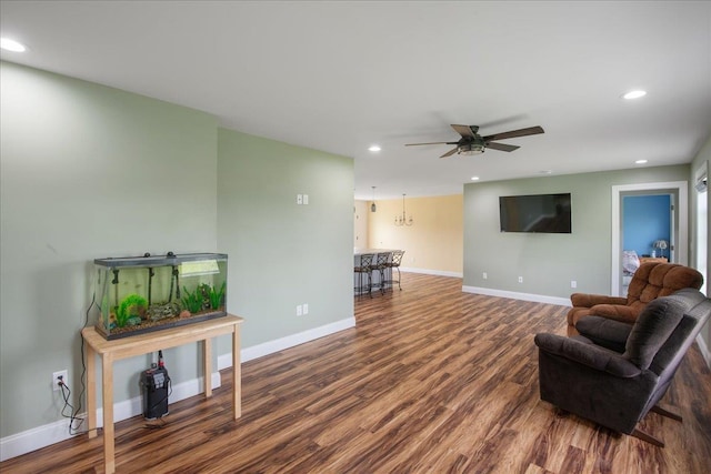 living room featuring baseboards, ceiling fan, recessed lighting, and wood finished floors