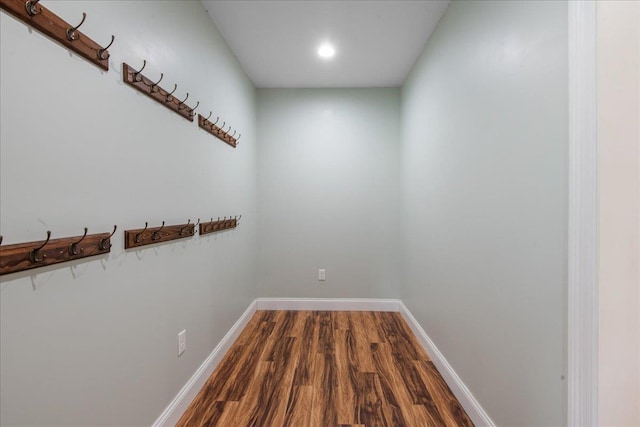 interior space featuring recessed lighting, baseboards, and dark wood-style floors