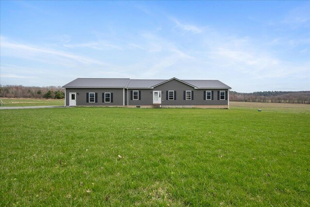 manufactured / mobile home with metal roof and a front yard