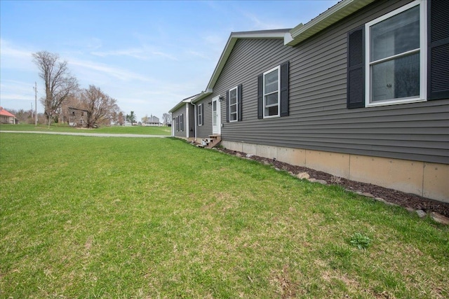 view of side of home with a lawn
