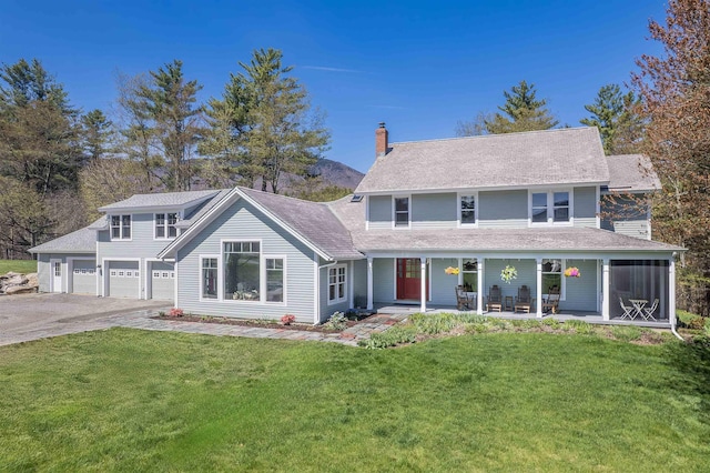 view of front of property featuring a garage, a front lawn, aphalt driveway, a chimney, and a porch