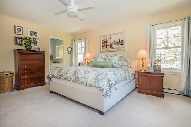 bedroom featuring ensuite bathroom, a ceiling fan, and light colored carpet