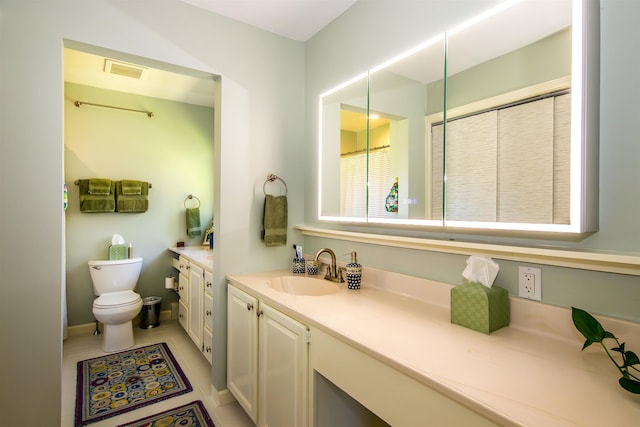 bathroom featuring vanity, tile patterned flooring, visible vents, and toilet
