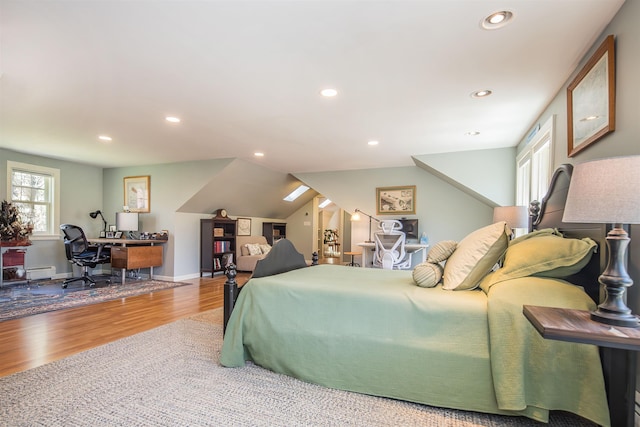 bedroom with baseboard heating, recessed lighting, baseboards, wood finished floors, and lofted ceiling