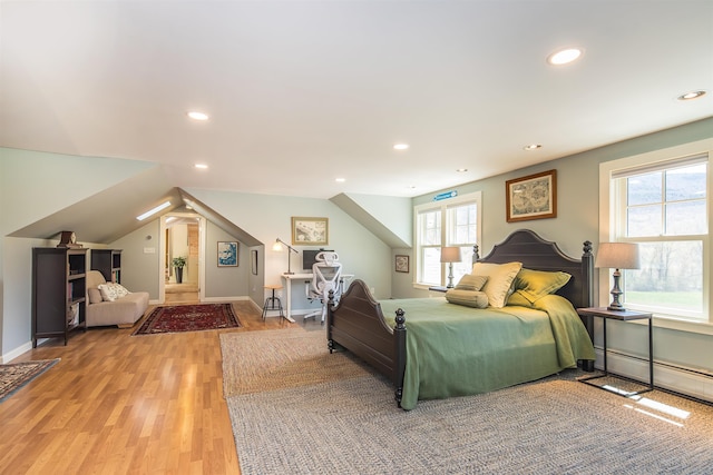 bedroom featuring recessed lighting, baseboards, a baseboard heating unit, and light wood finished floors