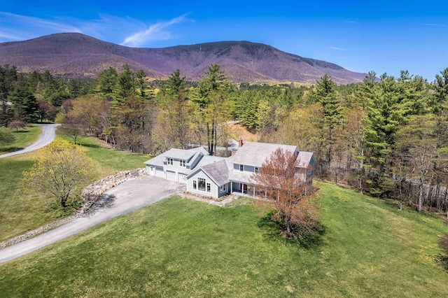 drone / aerial view with a mountain view and a forest view