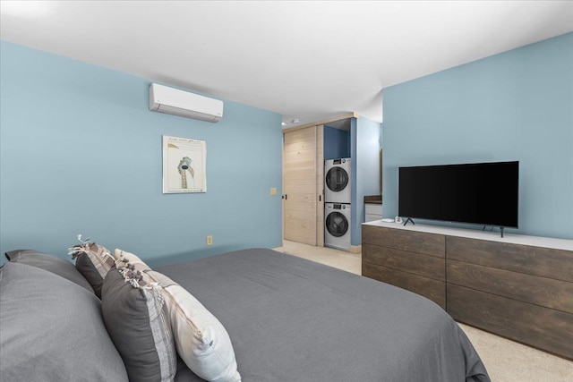 carpeted bedroom with a wall mounted air conditioner and stacked washer and clothes dryer