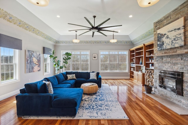 living room with baseboards, ceiling fan, a healthy amount of sunlight, and wood finished floors