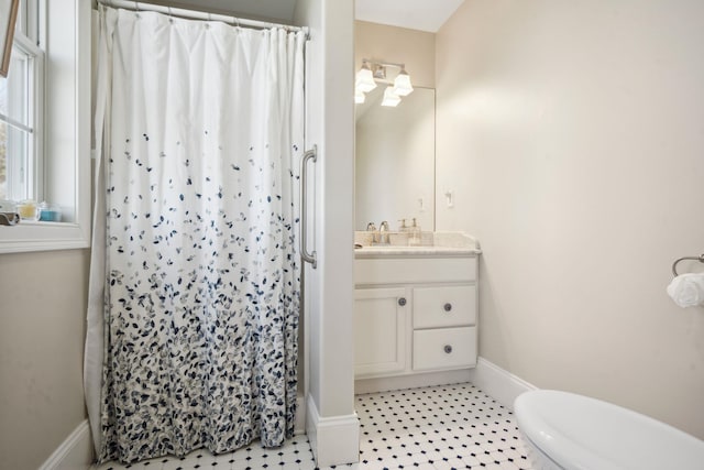 full bath with baseboards, vanity, toilet, and a shower with shower curtain