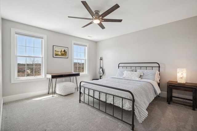 carpeted bedroom with baseboards and ceiling fan