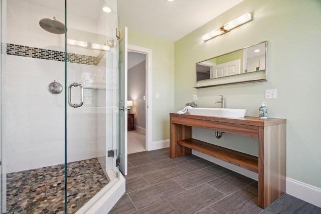 full bathroom featuring baseboards, recessed lighting, vanity, and a shower stall