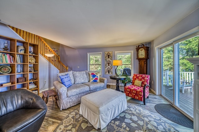 living room with stairway, baseboards, and wood finished floors
