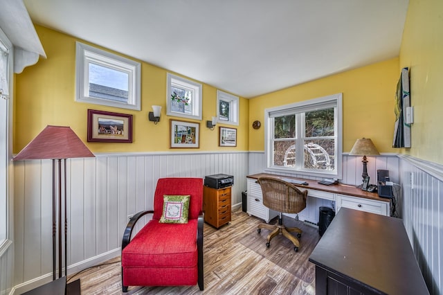 home office featuring wainscoting and wood finished floors