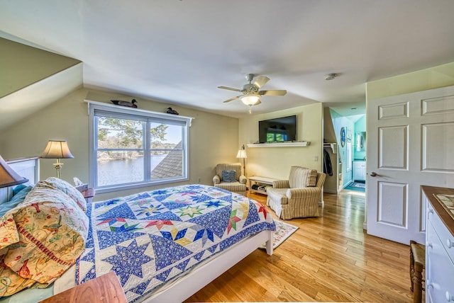 bedroom with light wood-style floors, a ceiling fan, and vaulted ceiling