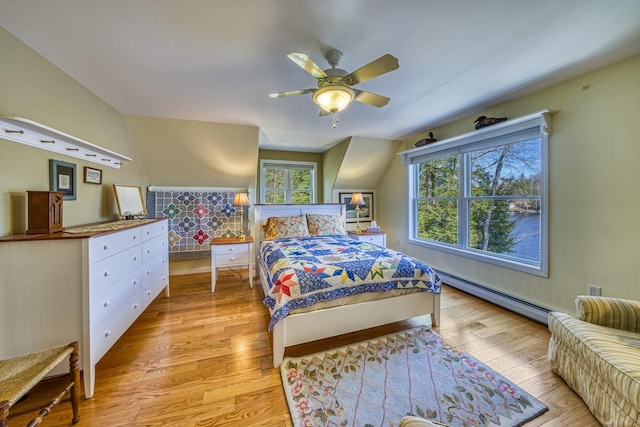 bedroom featuring ceiling fan, light wood-type flooring, and a baseboard radiator