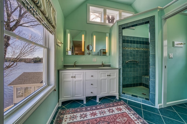 bathroom with a walk in shower, a water view, a sink, and tile patterned flooring