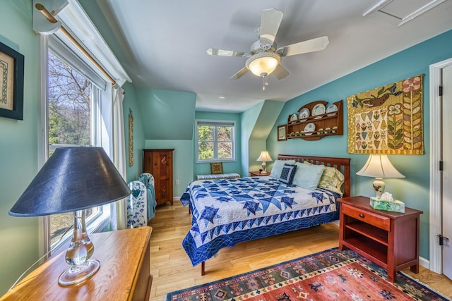 bedroom featuring baseboards, ceiling fan, and wood finished floors