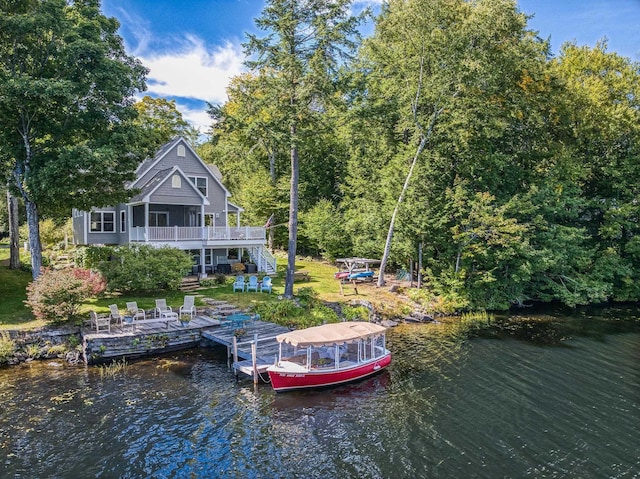 view of dock featuring stairs and a deck with water view
