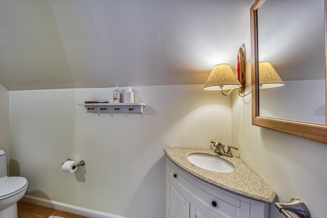 half bathroom with vanity and toilet