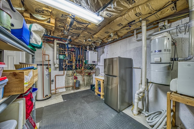 unfinished below grade area with freestanding refrigerator, water heater, and gas water heater