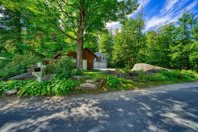 view of front of house with an outdoor structure and a garage