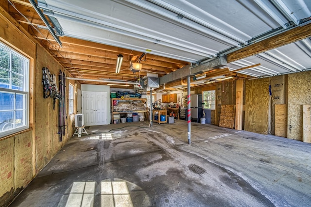 garage with freestanding refrigerator and a garage door opener