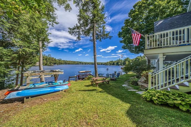 view of yard featuring stairs and a water view