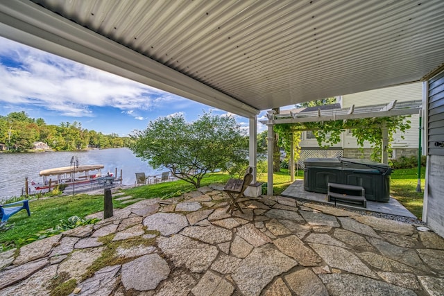 view of patio / terrace with a water view, a hot tub, and a dock