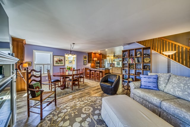 living room featuring wood finished floors and a notable chandelier