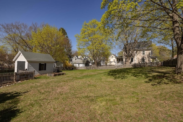view of yard featuring an outdoor structure and a fenced backyard