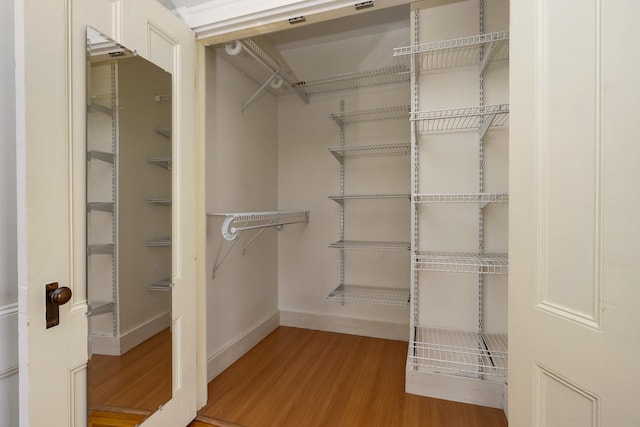spacious closet with wood finished floors