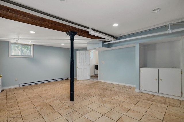 below grade area with light tile patterned floors, baseboards, a baseboard heating unit, and recessed lighting