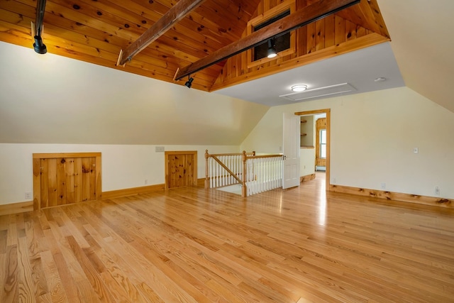 bonus room with baseboards, wood finished floors, and lofted ceiling