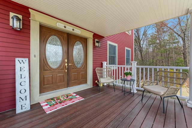 view of exterior entry featuring covered porch