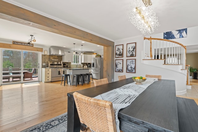 dining room with crown molding, light wood-style floors, stairway, recessed lighting, and a chandelier