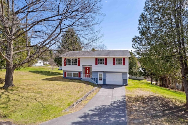 bi-level home with a garage, a front yard, and aphalt driveway