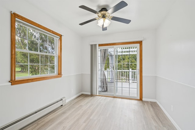 unfurnished room with baseboards, a ceiling fan, light wood-style flooring, and baseboard heating