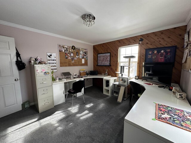 office featuring wooden walls, baseboards, ornamental molding, and dark colored carpet