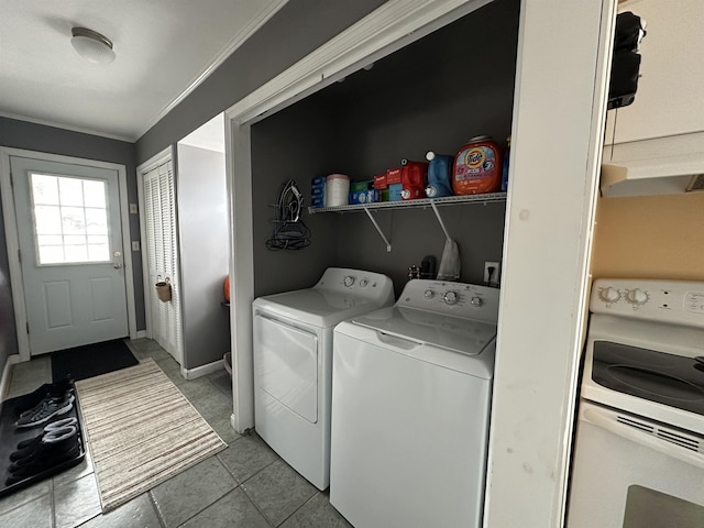 laundry area with washer and clothes dryer, tile patterned floors, and ornamental molding