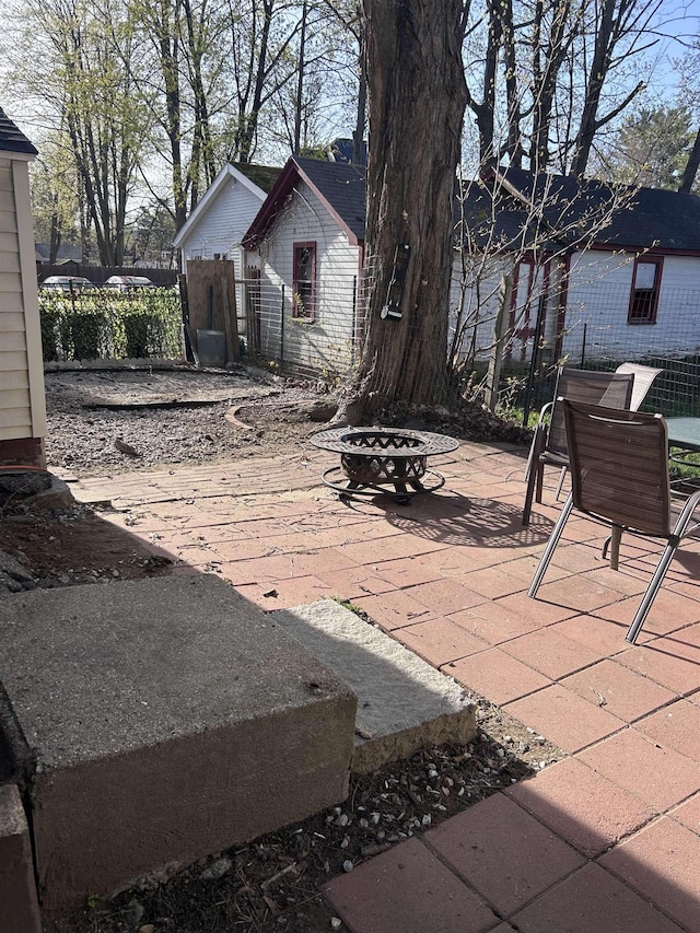 view of patio / terrace featuring fence and a fire pit
