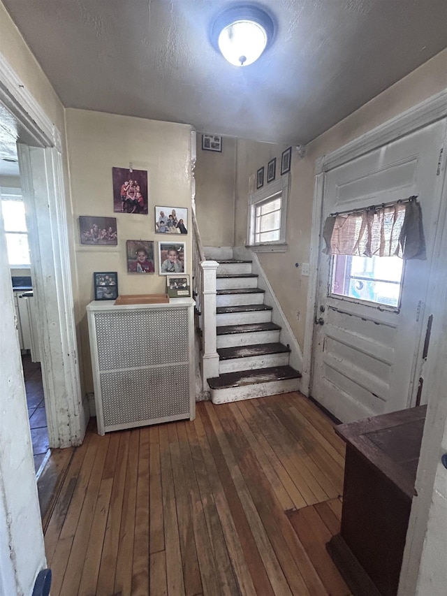 entryway featuring wood-type flooring and stairs