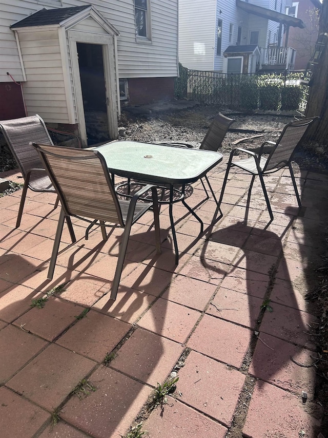 view of patio featuring fence and outdoor dining area