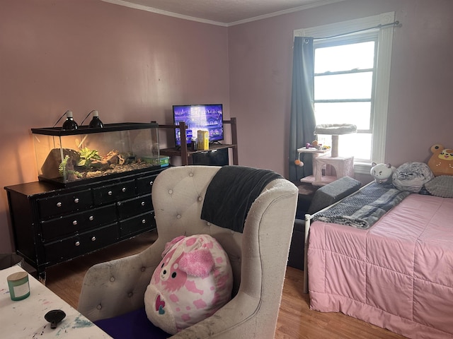 bedroom featuring crown molding, multiple windows, and wood finished floors