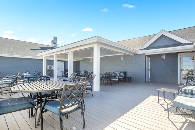 wooden terrace featuring outdoor dining area